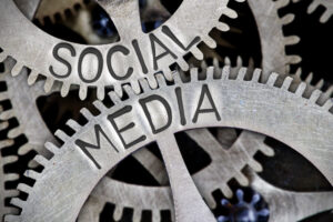 Macro photo of tooth wheel mechanism with SOCIAL MEDIA letters imprinted on metal surface